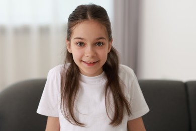 Photo of Portrait of beautiful little girl indoors. Cute child