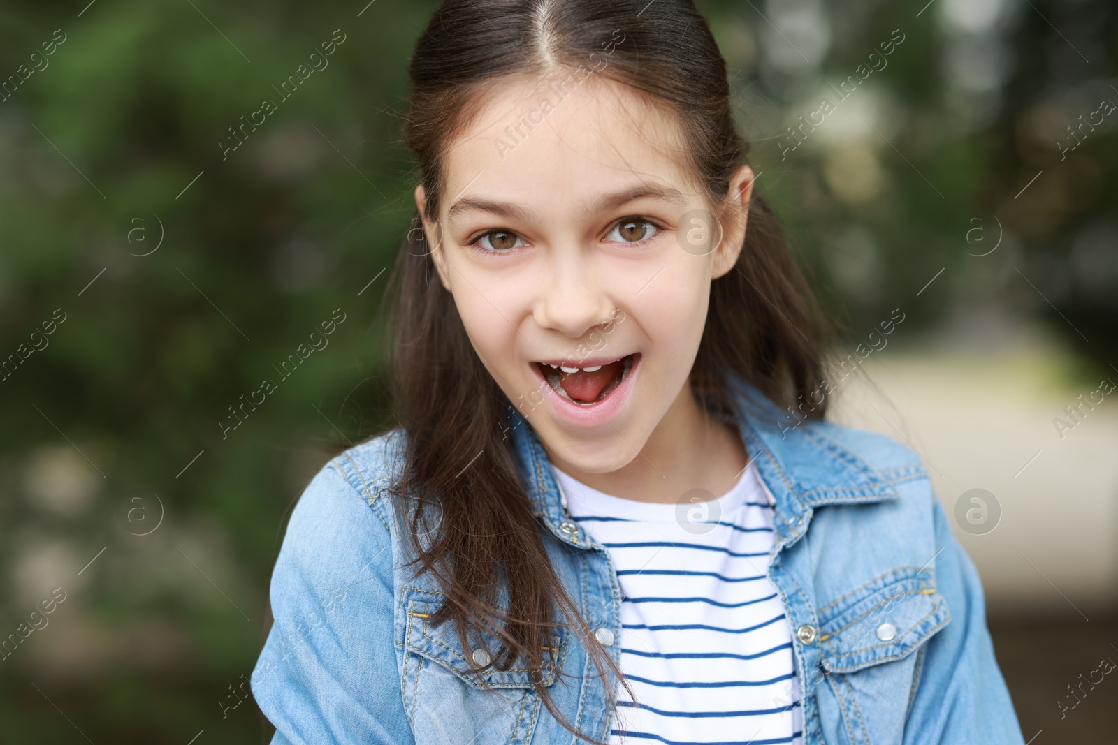 Photo of Portrait of emotional little girl outdoors. Cute child