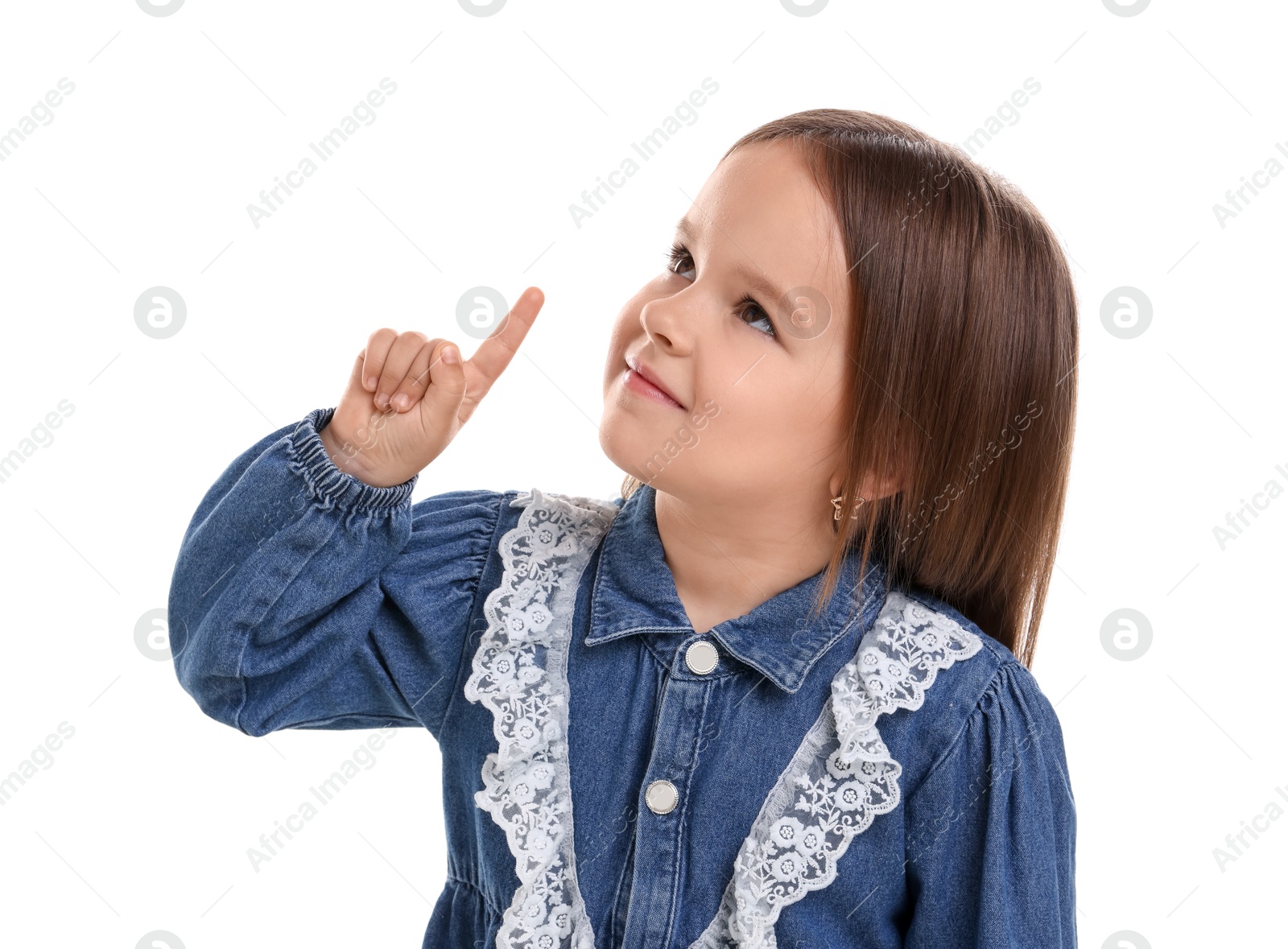 Photo of Portrait of cute little girl pointing at something on white background