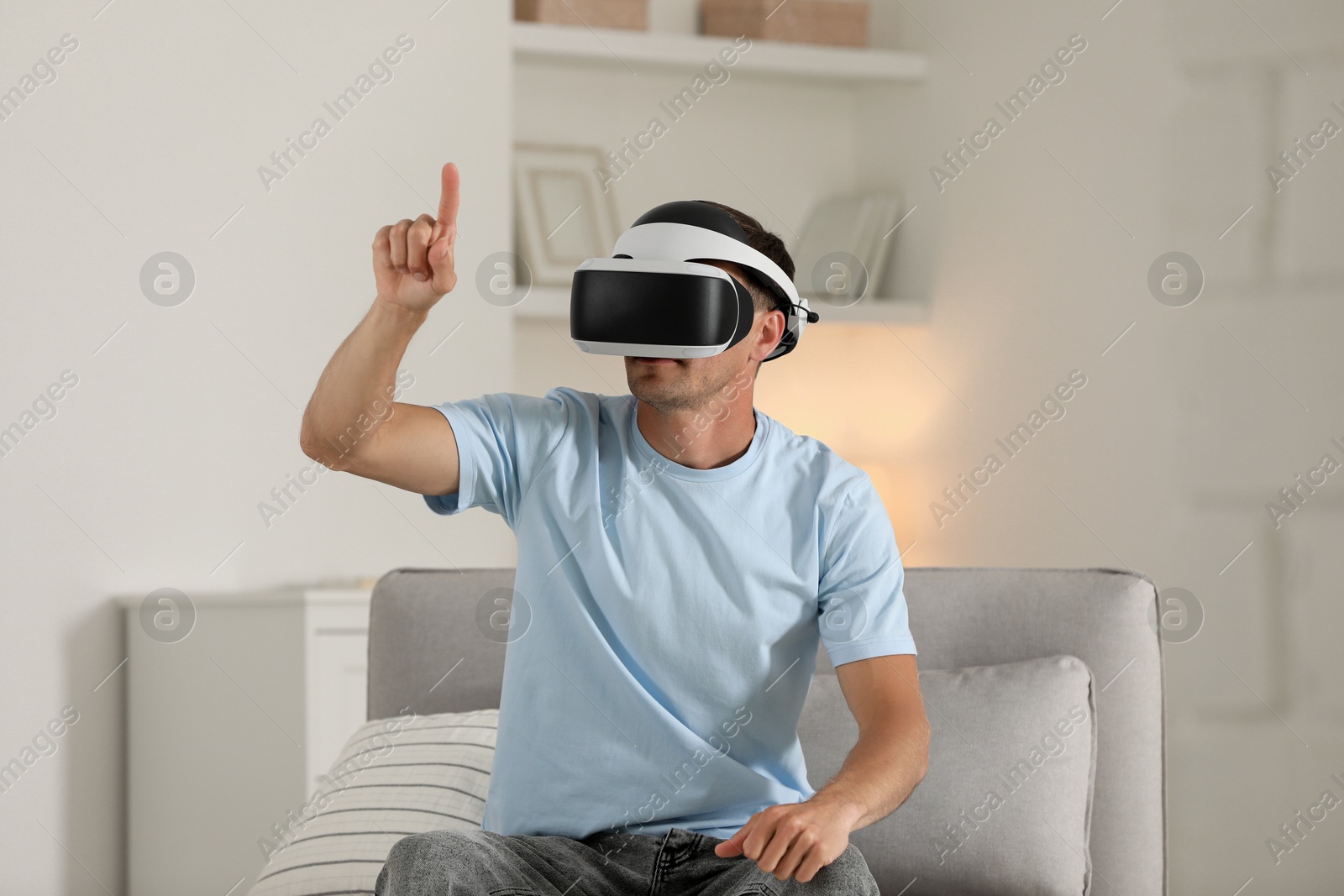 Photo of Man using virtual reality headset at home