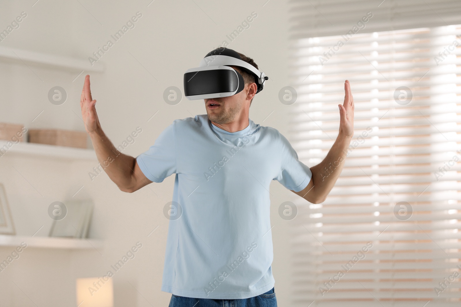 Photo of Man using virtual reality headset at home