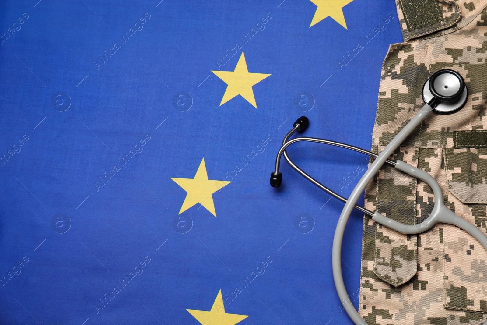 Photo of Stethoscope and military uniform on flag of European Union, top view