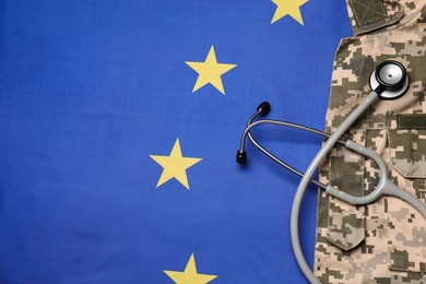 Stethoscope and military uniform on flag of European Union, top view