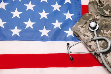 Photo of Stethoscope and military uniform on USA flag, above view