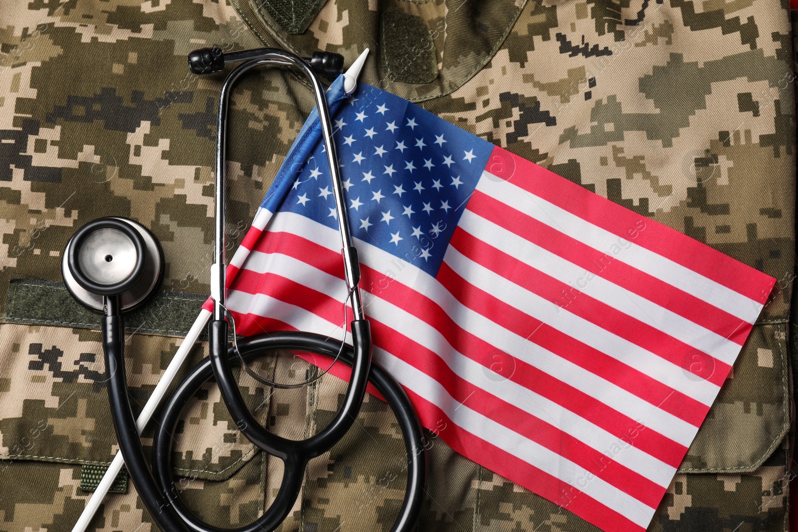 Photo of Stethoscope and USA flag on military uniform, top view