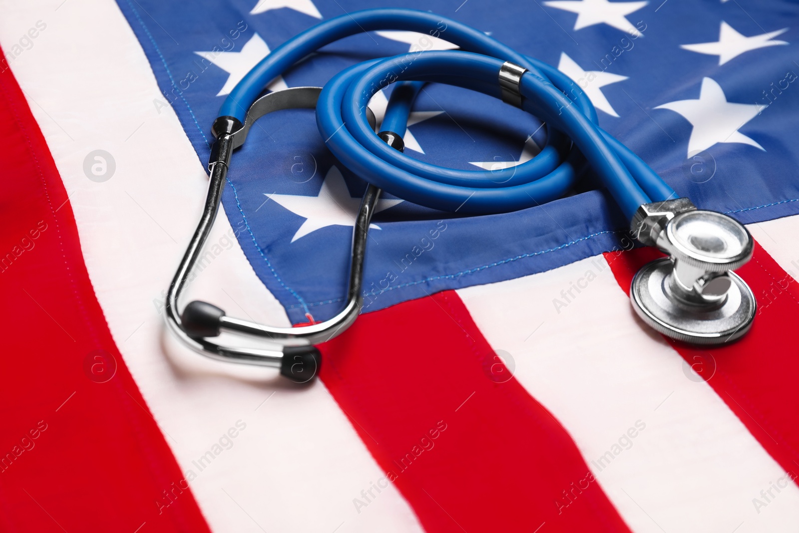 Photo of Stethoscope on USA flag, closeup. Health care concept