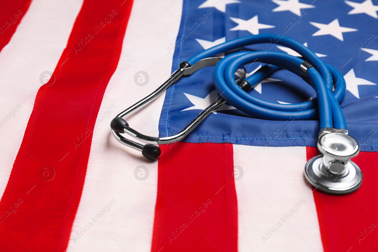 Photo of Stethoscope on USA flag, closeup. Health care concept