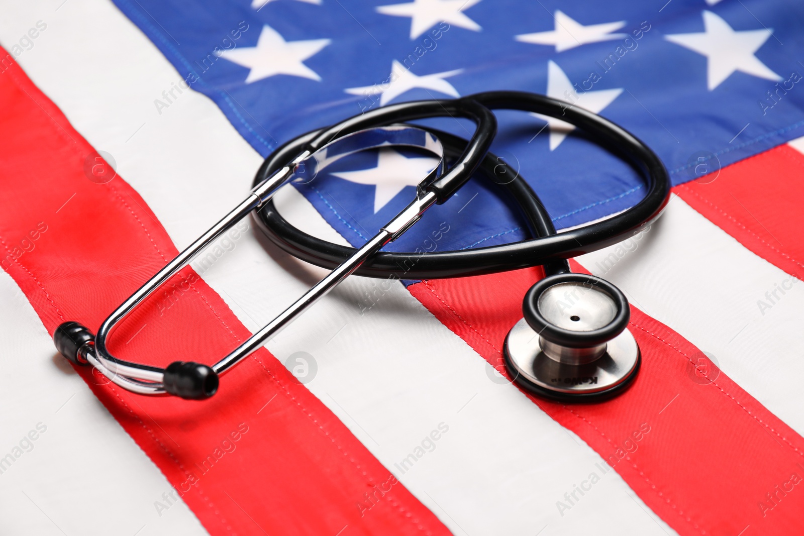 Photo of Stethoscope on USA flag, closeup. Health care concept