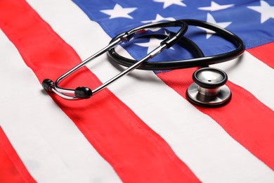 Photo of Stethoscope on USA flag, closeup. Health care concept