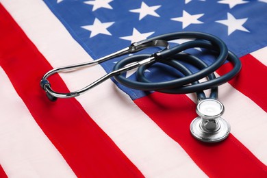 Photo of Stethoscope on USA flag, closeup. Health care concept