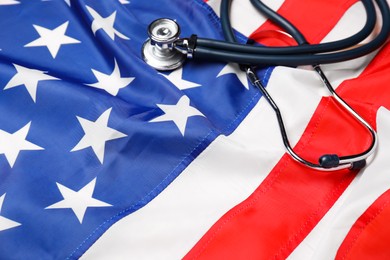 Photo of Stethoscope on USA flag, closeup. Health care concept