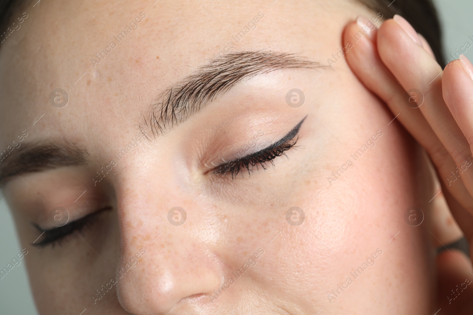 Photo of Young woman with beautiful eyebrows, closeup view