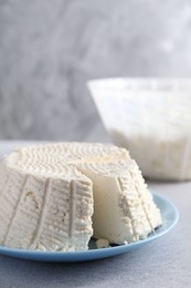 Tasty ricotta (cream cheese) on grey table, closeup