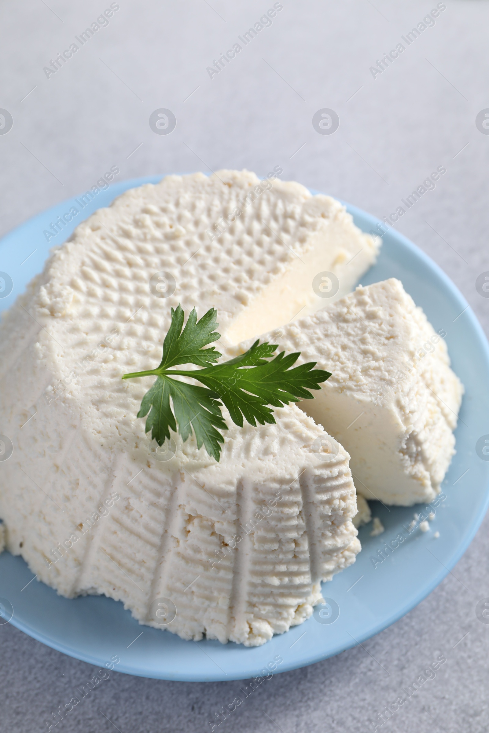 Photo of Tasty ricotta (cream cheese) on grey table