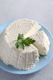 Tasty ricotta (cream cheese) on grey table