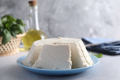 Photo of Tasty ricotta (cream cheese) on grey table