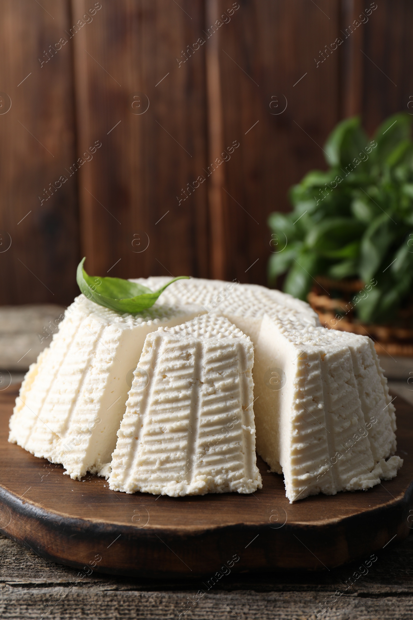 Photo of Tasty ricotta (cream cheese) on wooden table, closeup