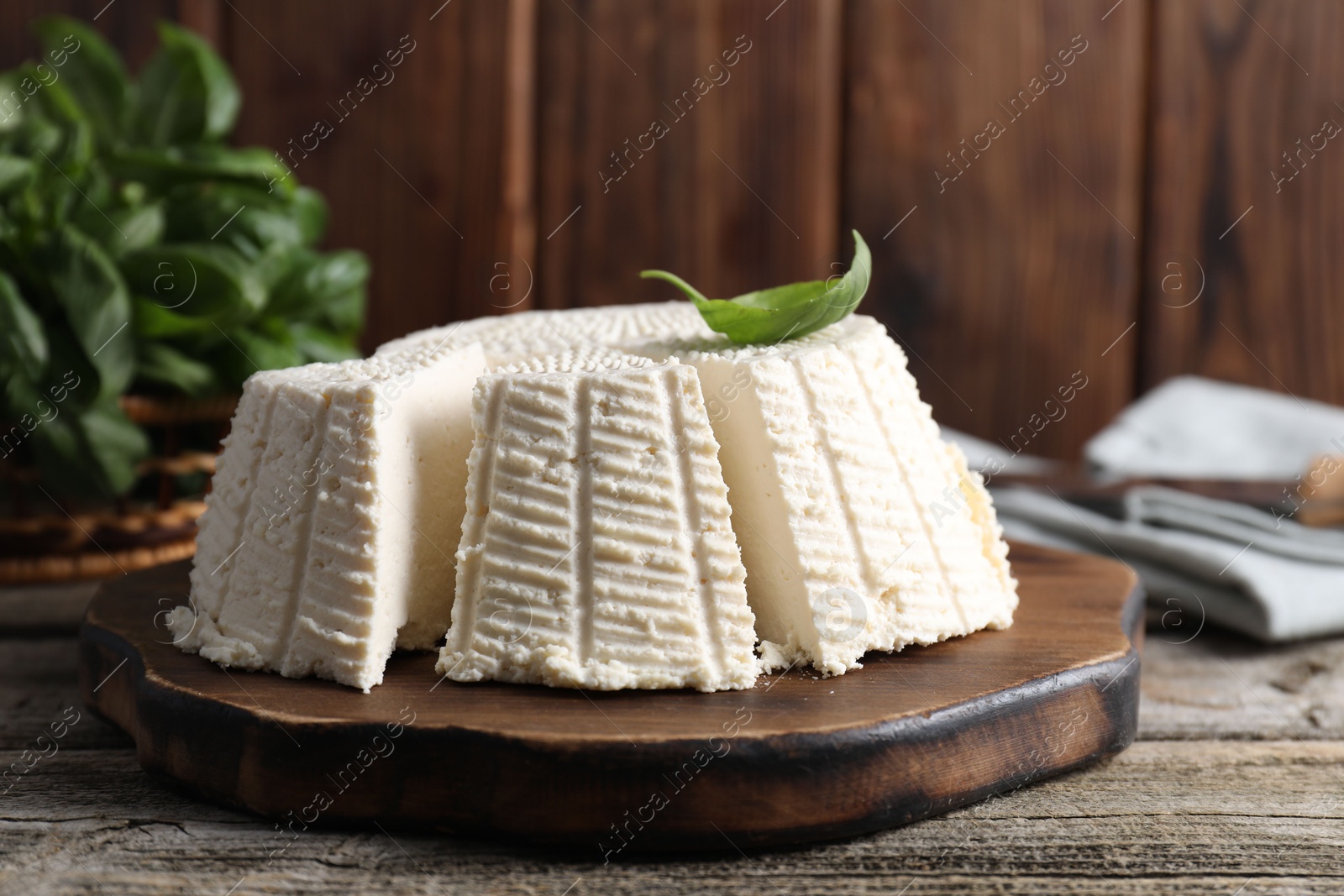 Photo of Tasty ricotta (cream cheese) on wooden table, closeup