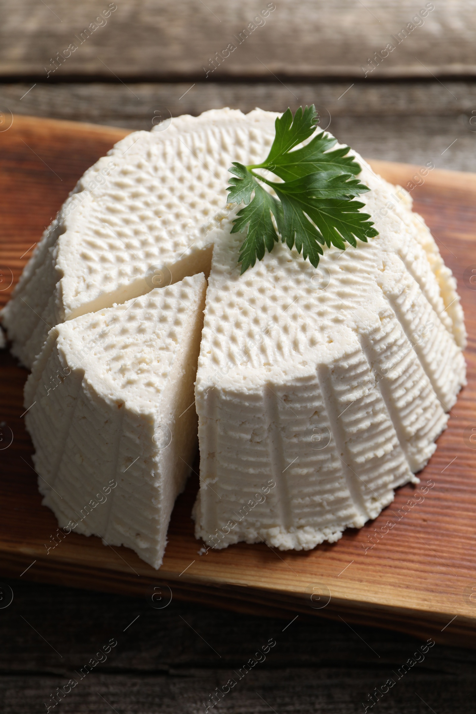 Photo of Tasty ricotta (cream cheese) on wooden table, closeup