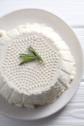 Tasty ricotta (cream cheese) on white wooden table, top view