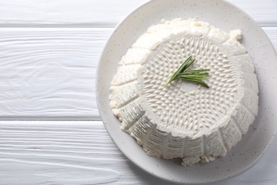 Tasty ricotta (cream cheese) on white wooden table, top view. Space for text