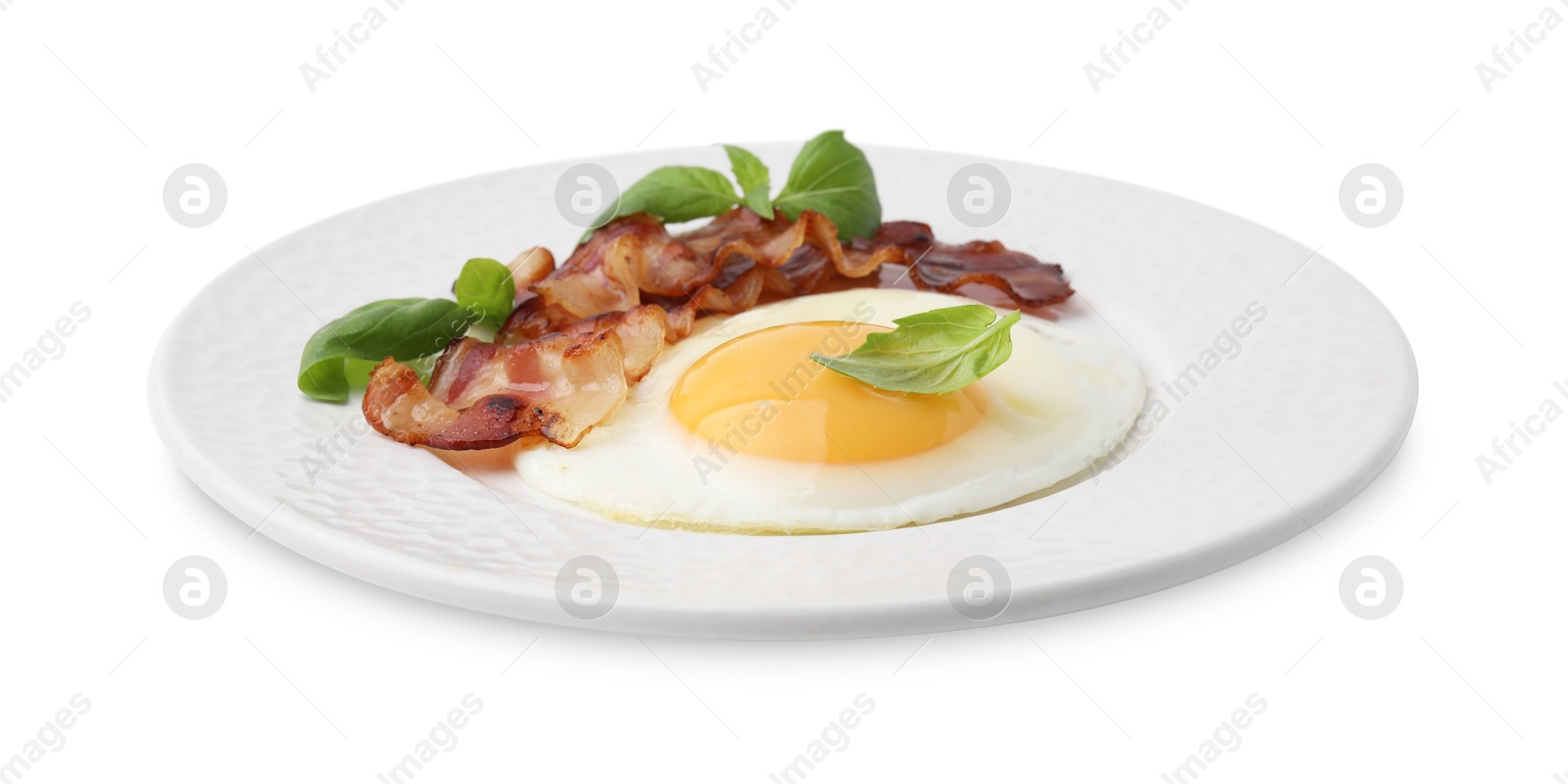 Photo of Fried egg, bacon and basil isolated on white