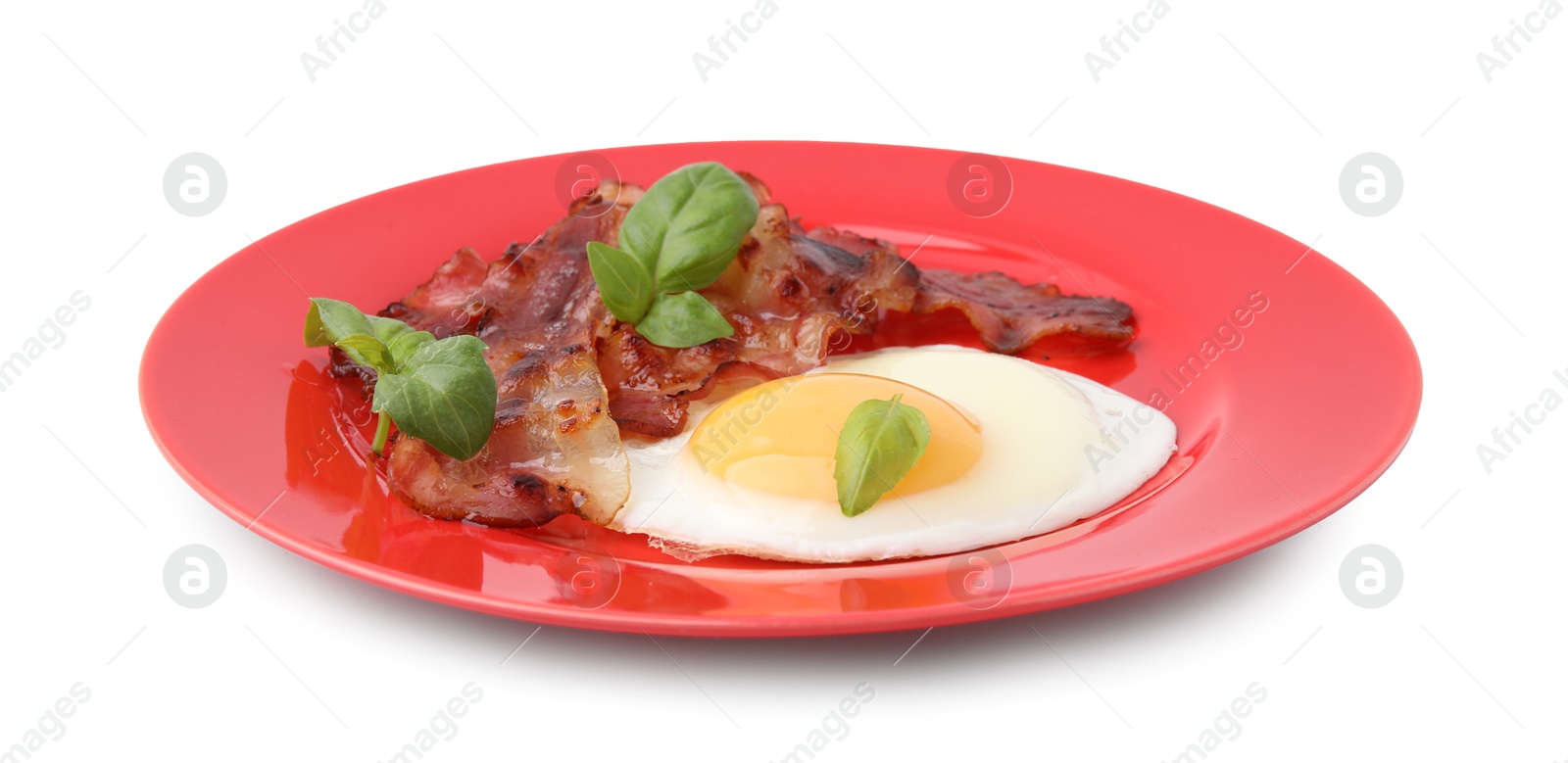Photo of Fried egg, bacon and basil isolated on white