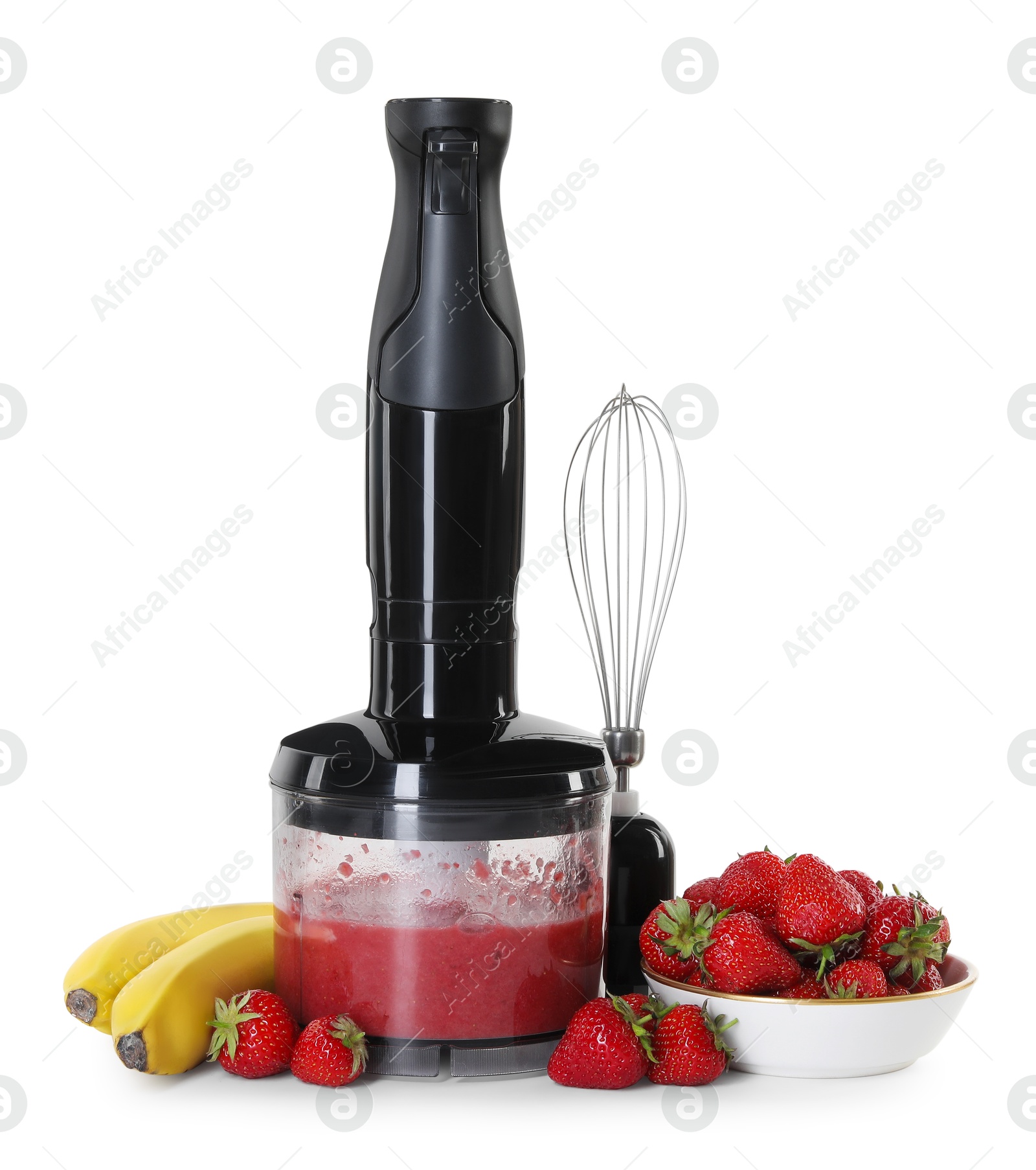 Photo of Hand blender with mixture of ingredients, fresh fruits and whisk isolated on white