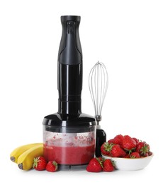 Hand blender with mixture of ingredients, fresh fruits and whisk isolated on white