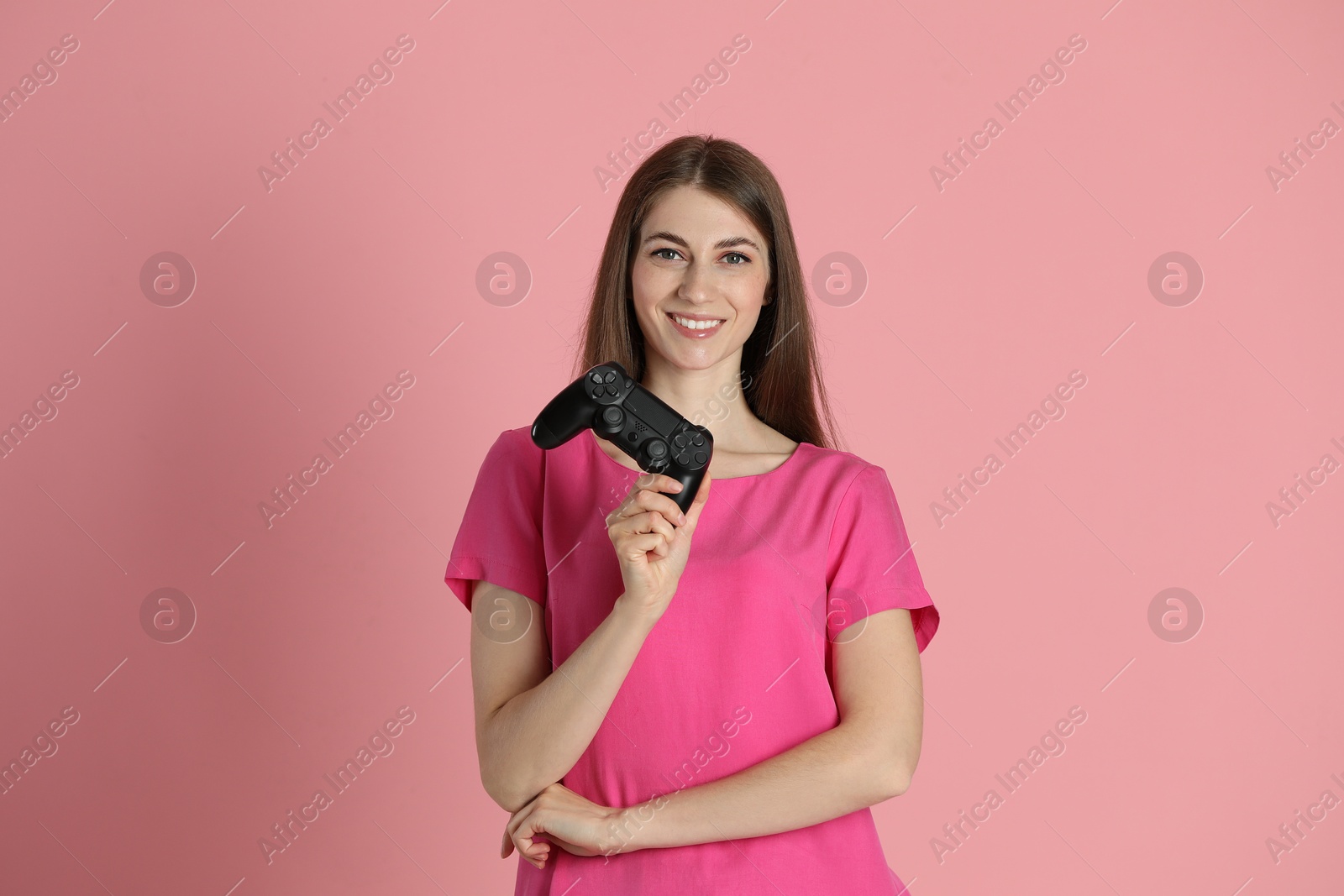 Photo of Happy woman with controller on pink background