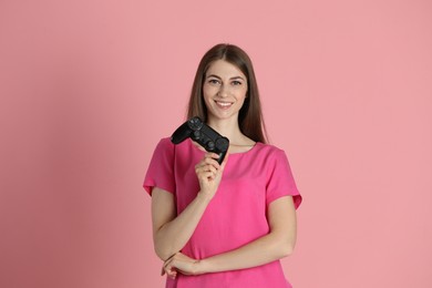 Photo of Happy woman with controller on pink background