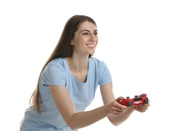 Happy woman playing video games with controller on white background