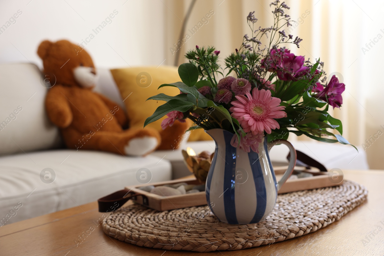 Photo of Bouquet of beautiful flowers in vase on wooden table at home. Space for text