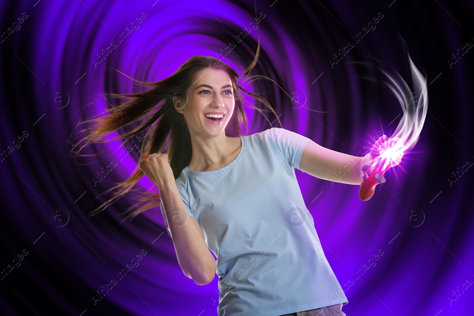 Image of Excited woman playing video game with controller on color background. Light coming out from device