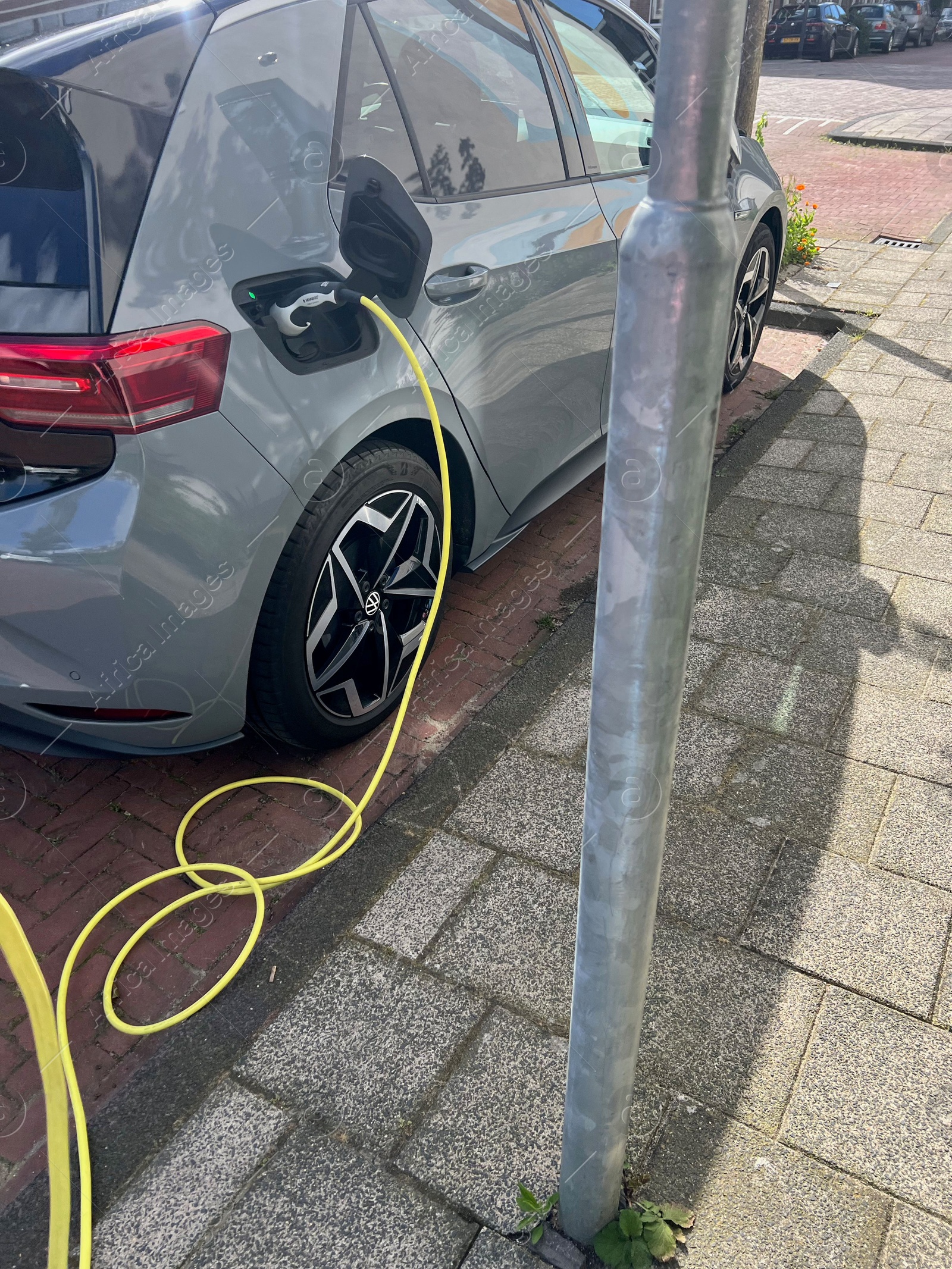 Photo of Modern electric car charging from station outdoors