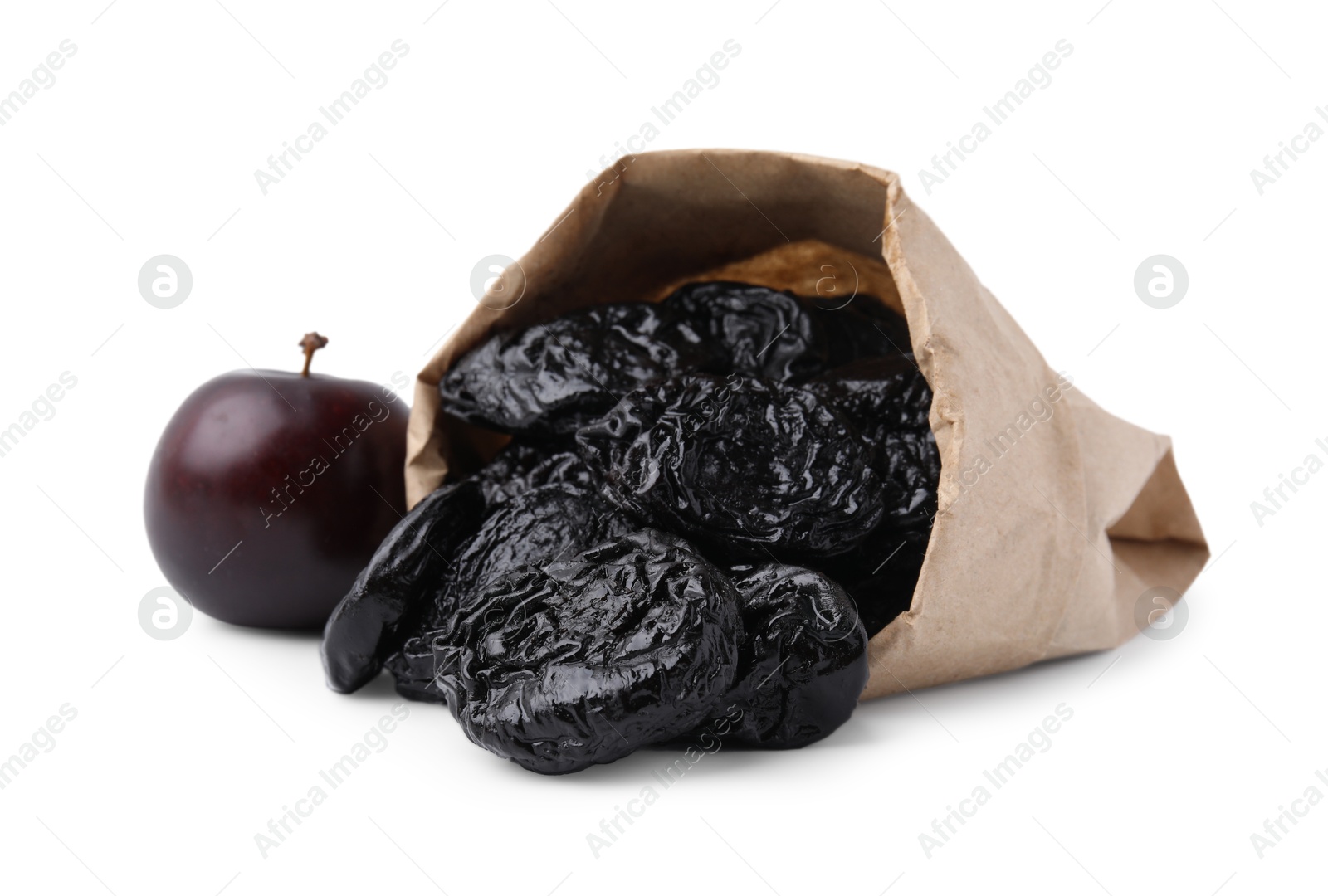 Photo of Paper bag with delicious prunes and fresh ripe plum isolated on white