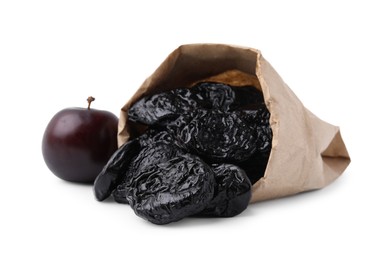 Photo of Paper bag with delicious prunes and fresh ripe plum isolated on white