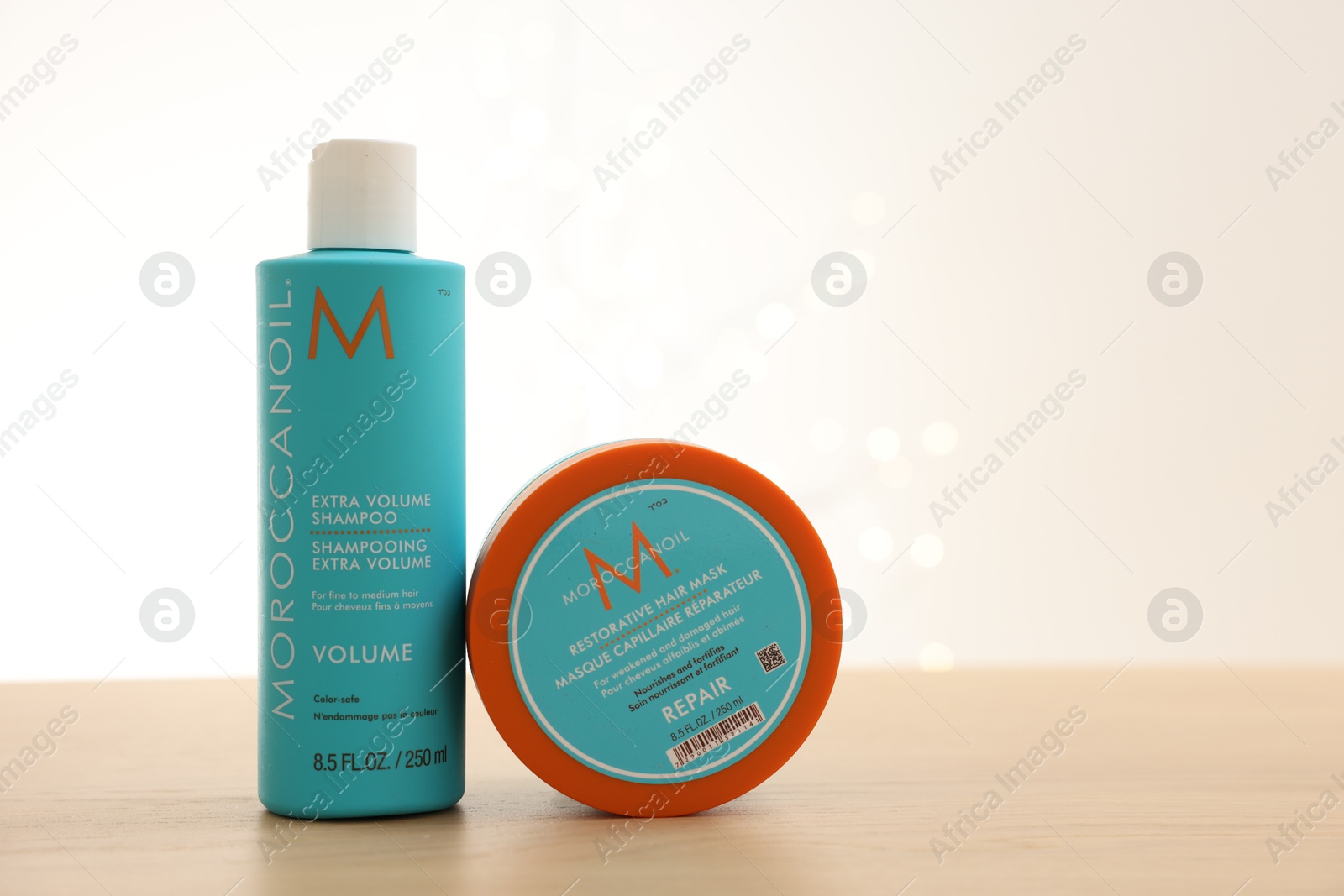 Photo of Leiden, Netherlands - June 11, 2024: Moroccanoil hair care cosmetic products on wooden table against light background, space for text