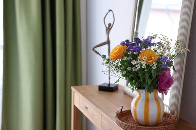 Vase with beautiful flowers on wooden table indoors, space for text