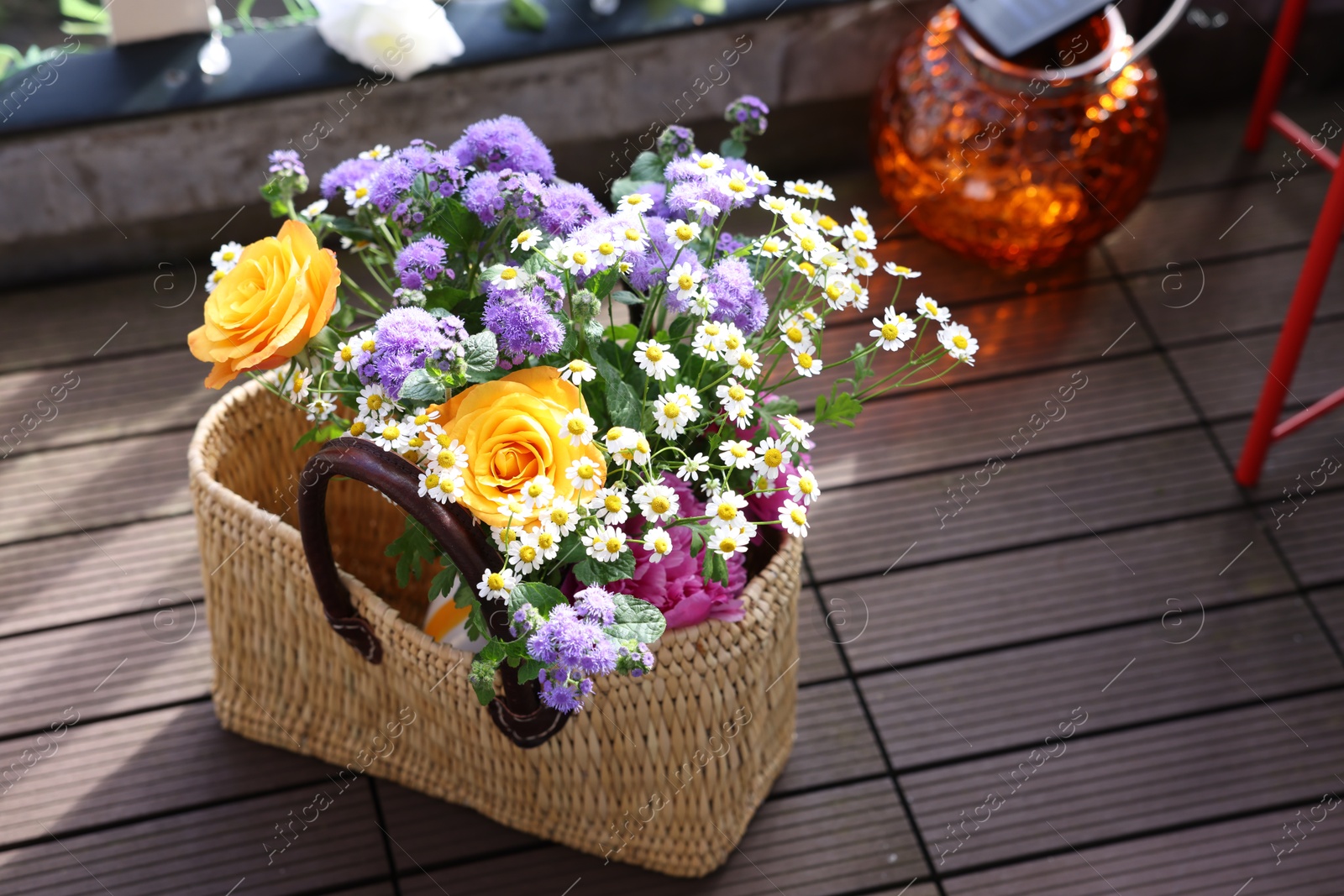 Photo of Wicker basket with beautiful aromatic flowers outdoors