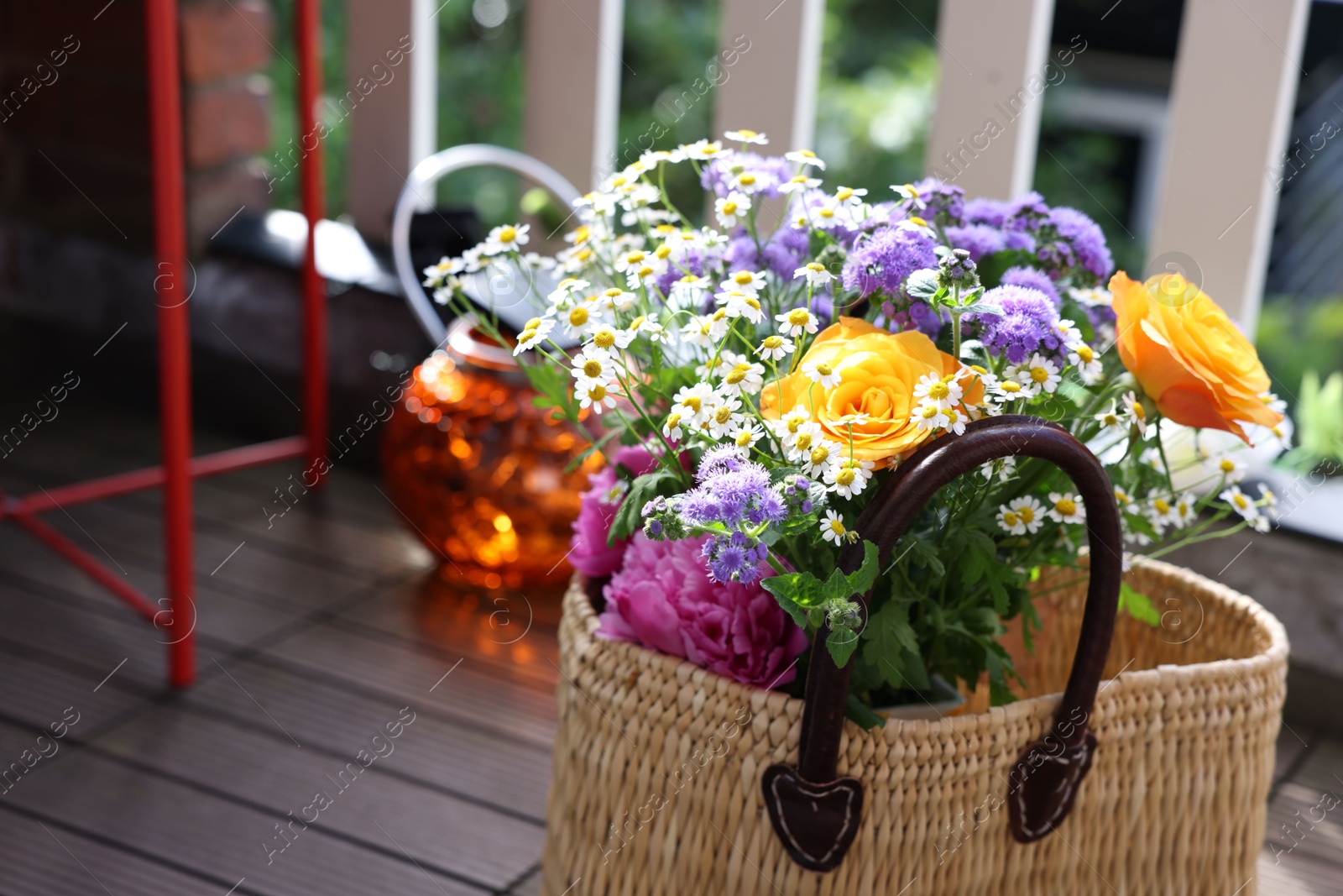 Photo of Wicker basket with beautiful aromatic flowers outdoors, closeup. Space for text