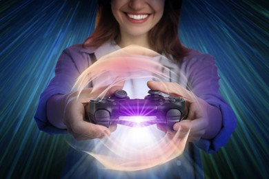 Image of Happy woman playing video game with controller on color background, motion blur effect. Light around device