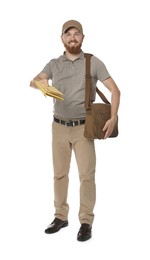 Happy young postman with brown bag delivering letters on white background