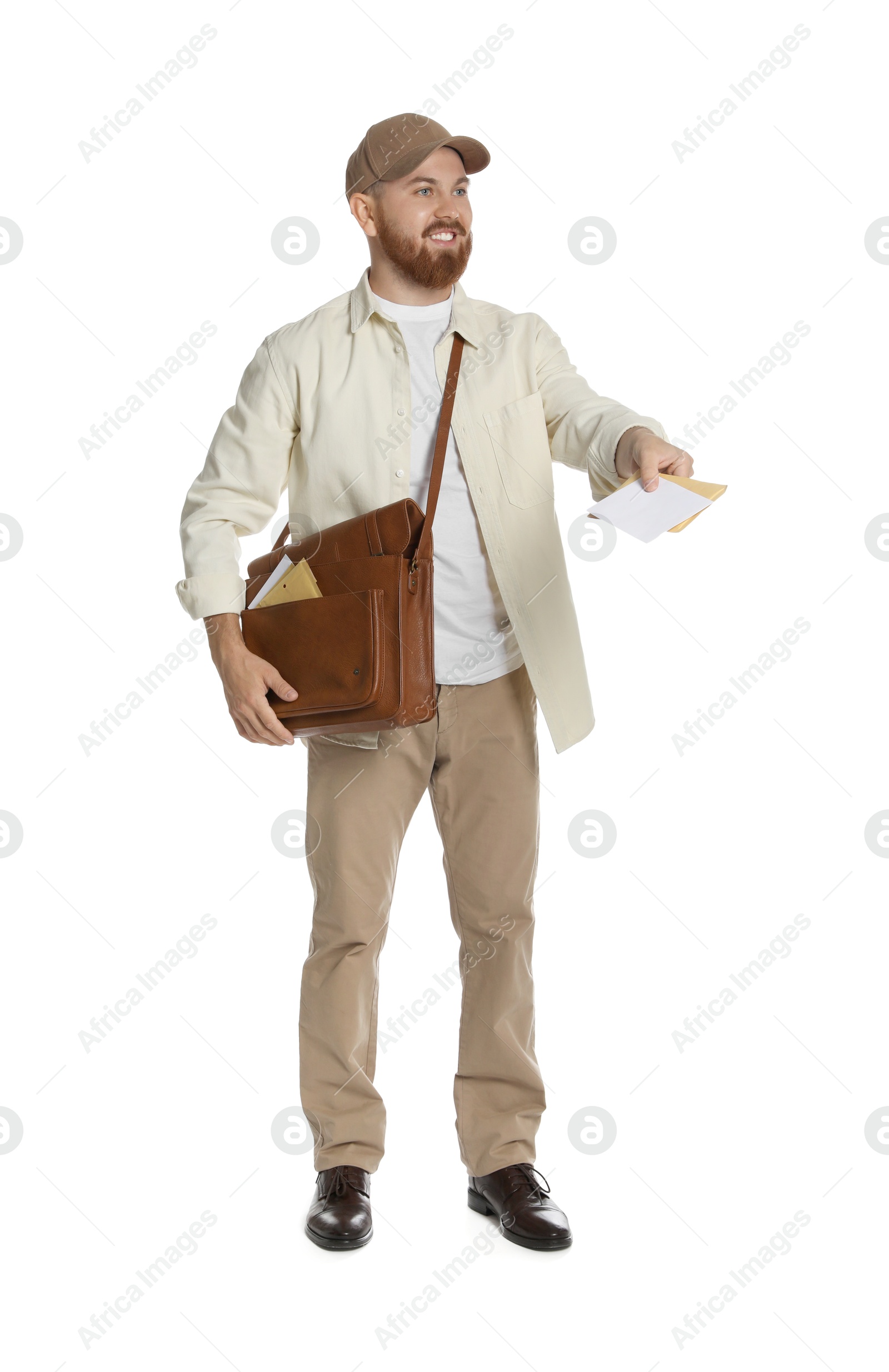 Photo of Happy young postman with brown bag delivering letters on white background