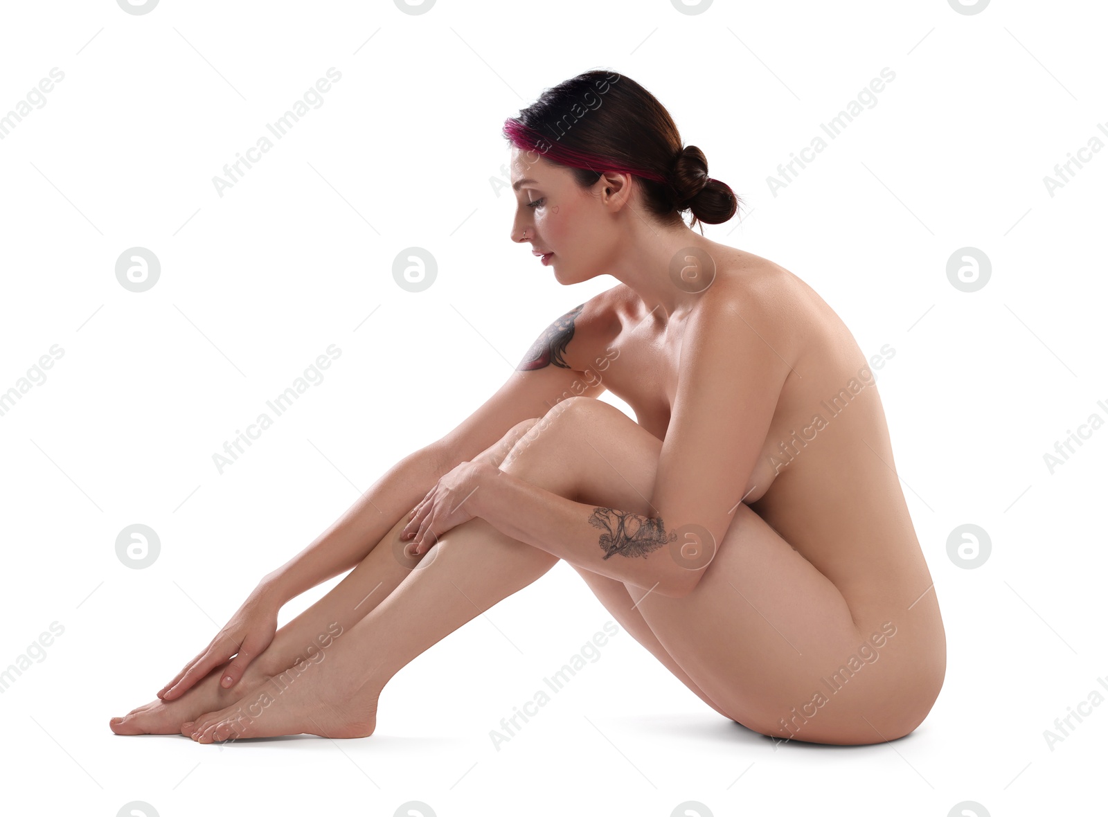 Photo of Beautiful nude woman with tattoos posing on white background