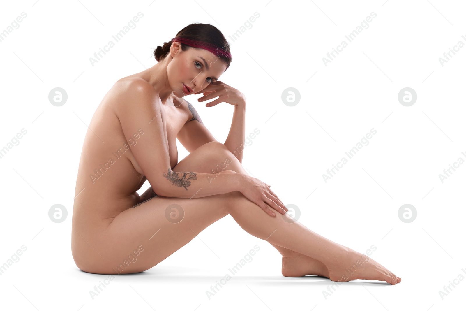 Photo of Beautiful nude woman with tattoos posing on white background