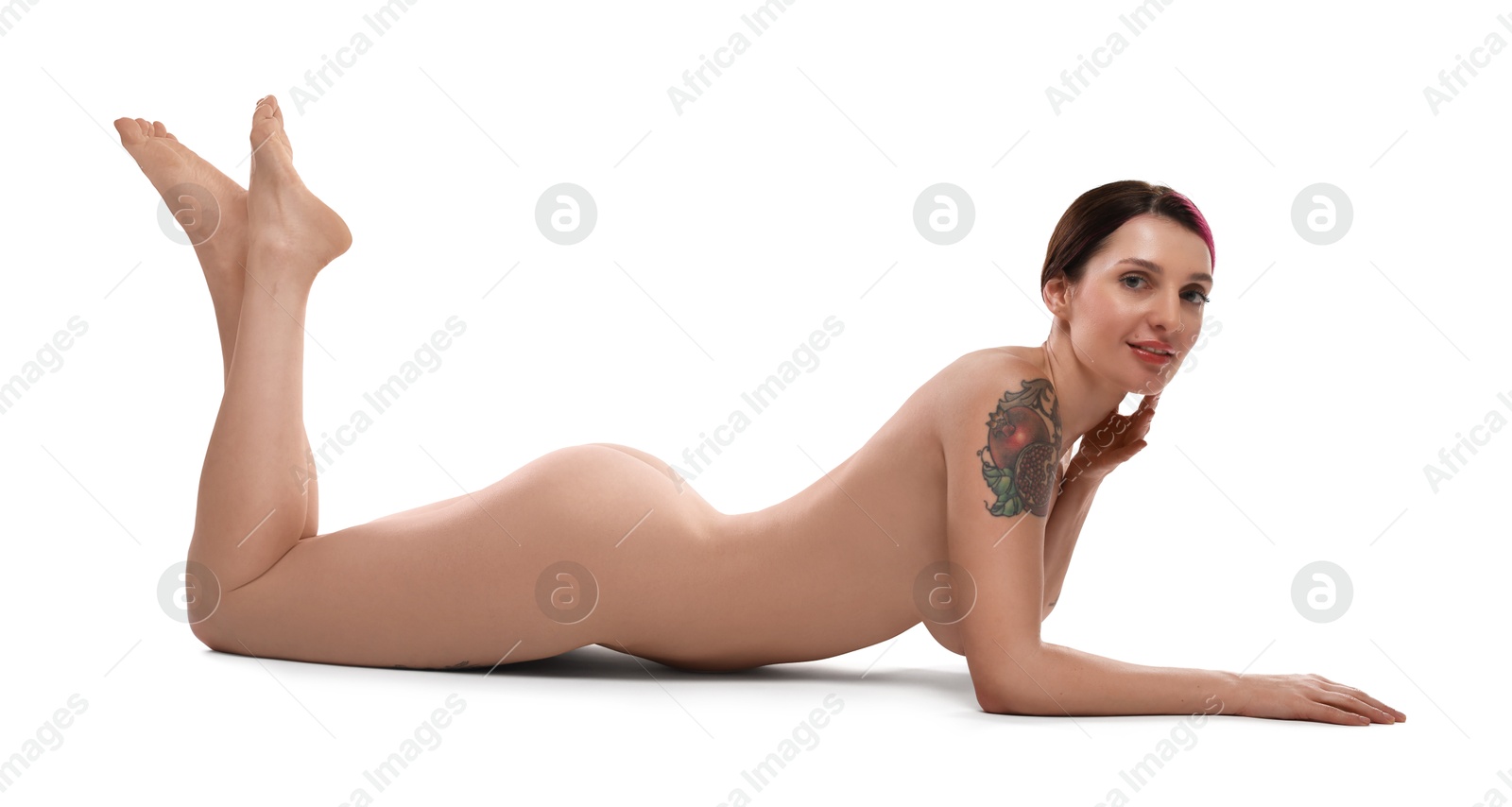 Photo of Beautiful nude woman with tattoos posing on white background