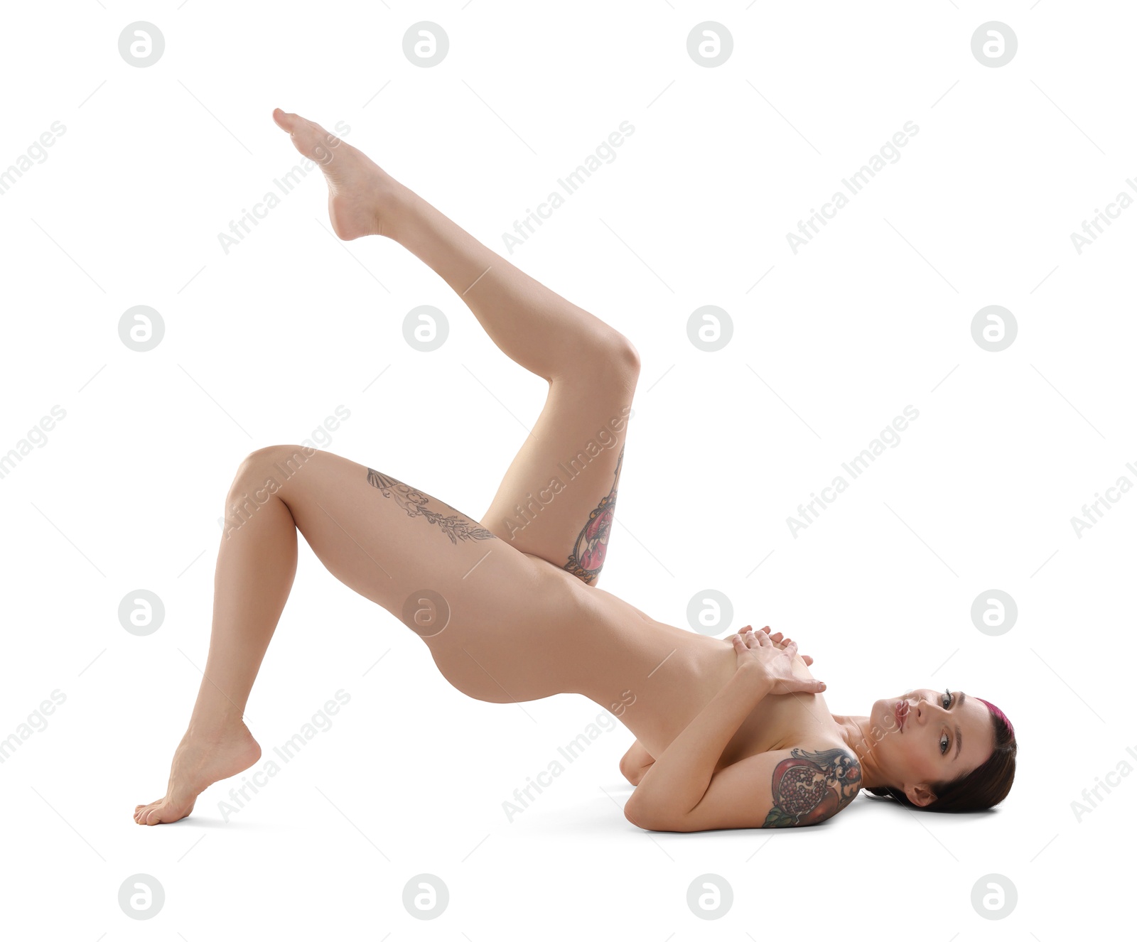 Photo of Beautiful nude woman with tattoos posing on white background