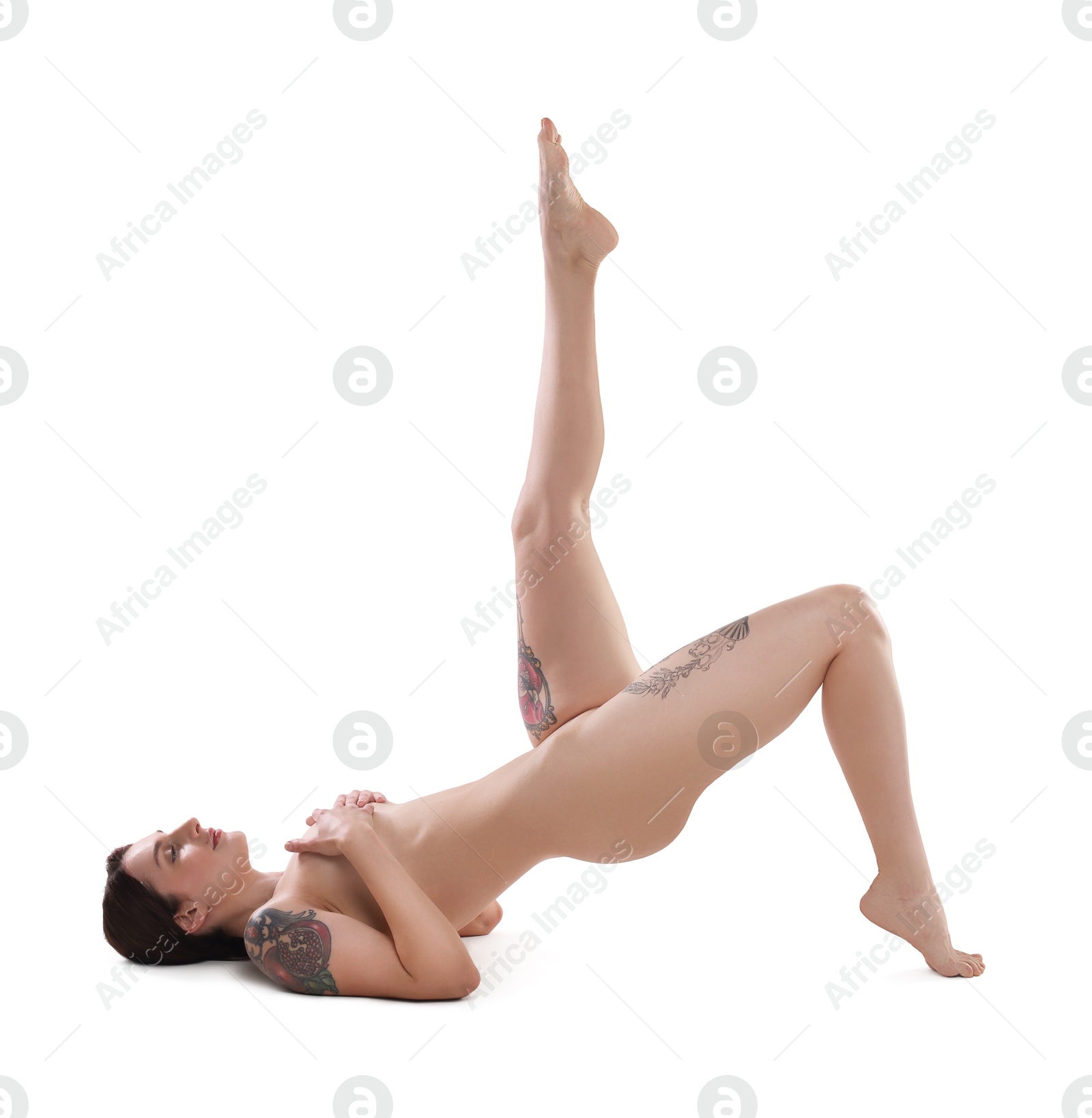 Photo of Beautiful nude woman with tattoos posing on white background