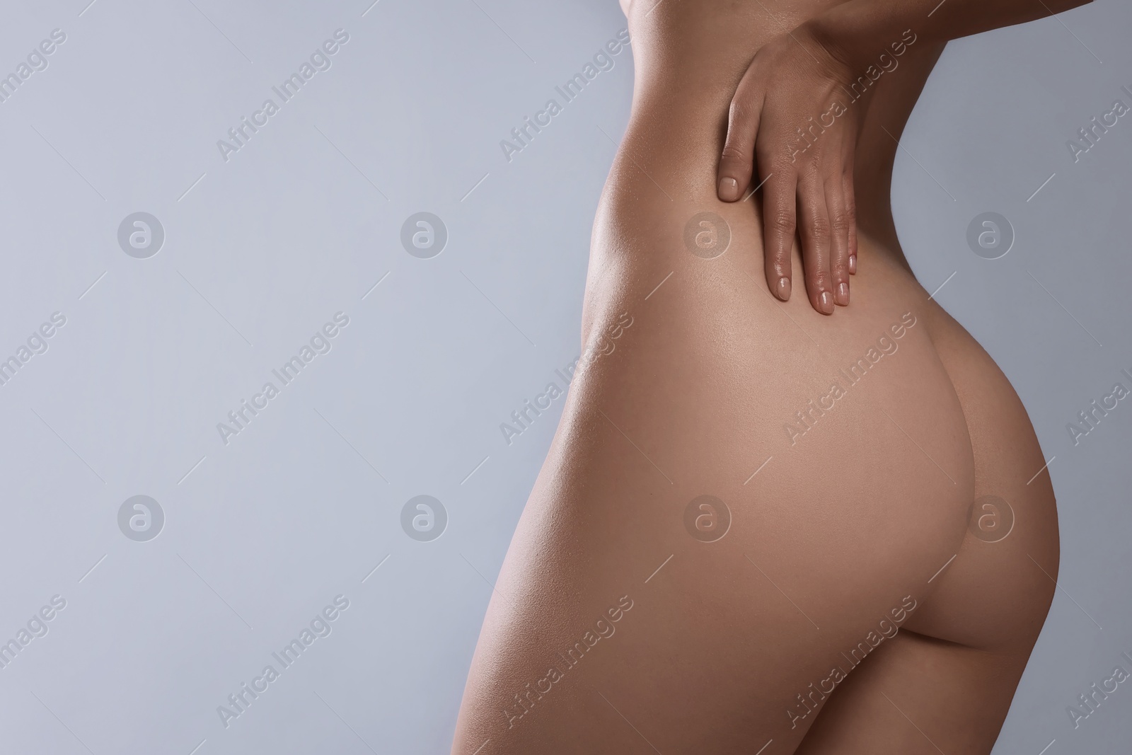 Photo of Nude woman on light grey background, closeup. Space for text